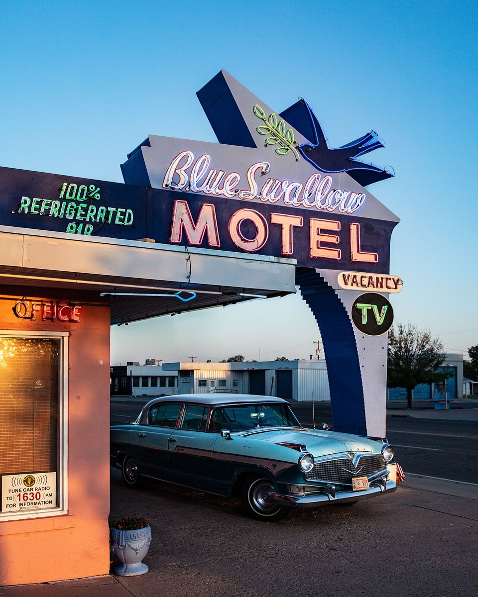 Blue Swallow Motel neon sign and vintage car in Tucumcari