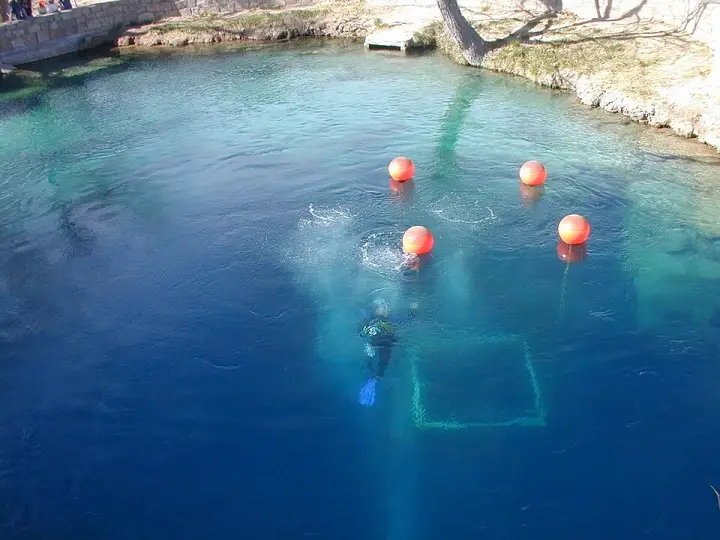 A scuba diver in the clear water of the Blue Hole in Santa Rosa