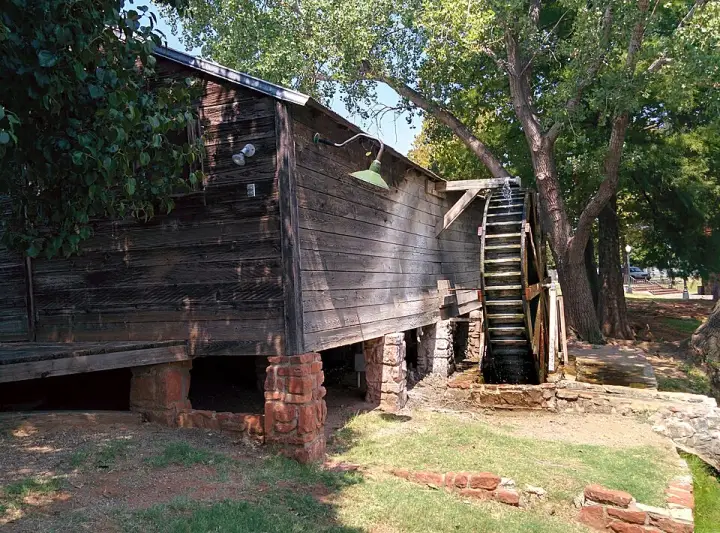 The Whited Grist Mill and its painted sign at the National Route 66 & Transportation Museum